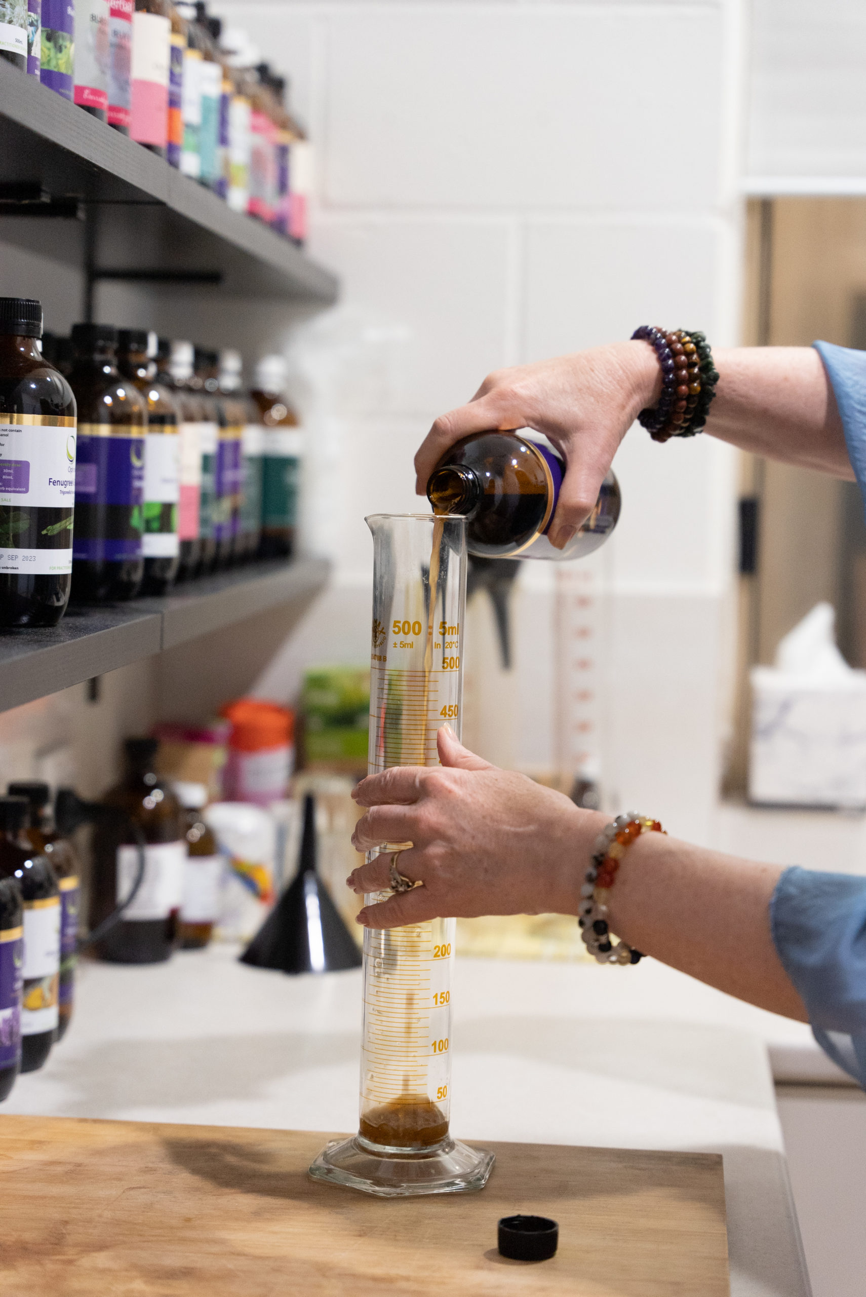 Linda pouring herbs in Clinic